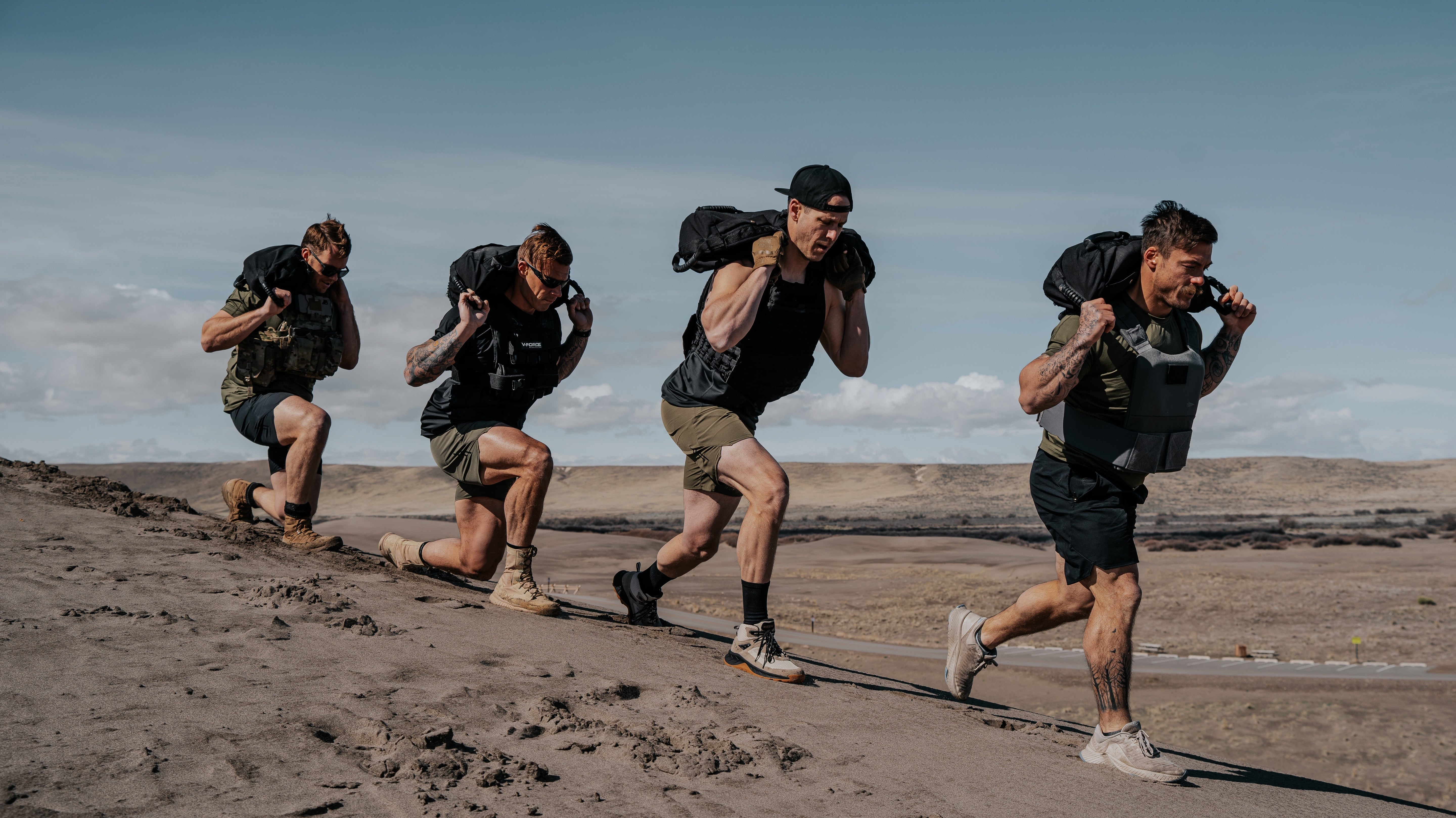 LINEAR Clothing athletes working out wearing weighted vests and carrying out various exercises in the sand dunes.