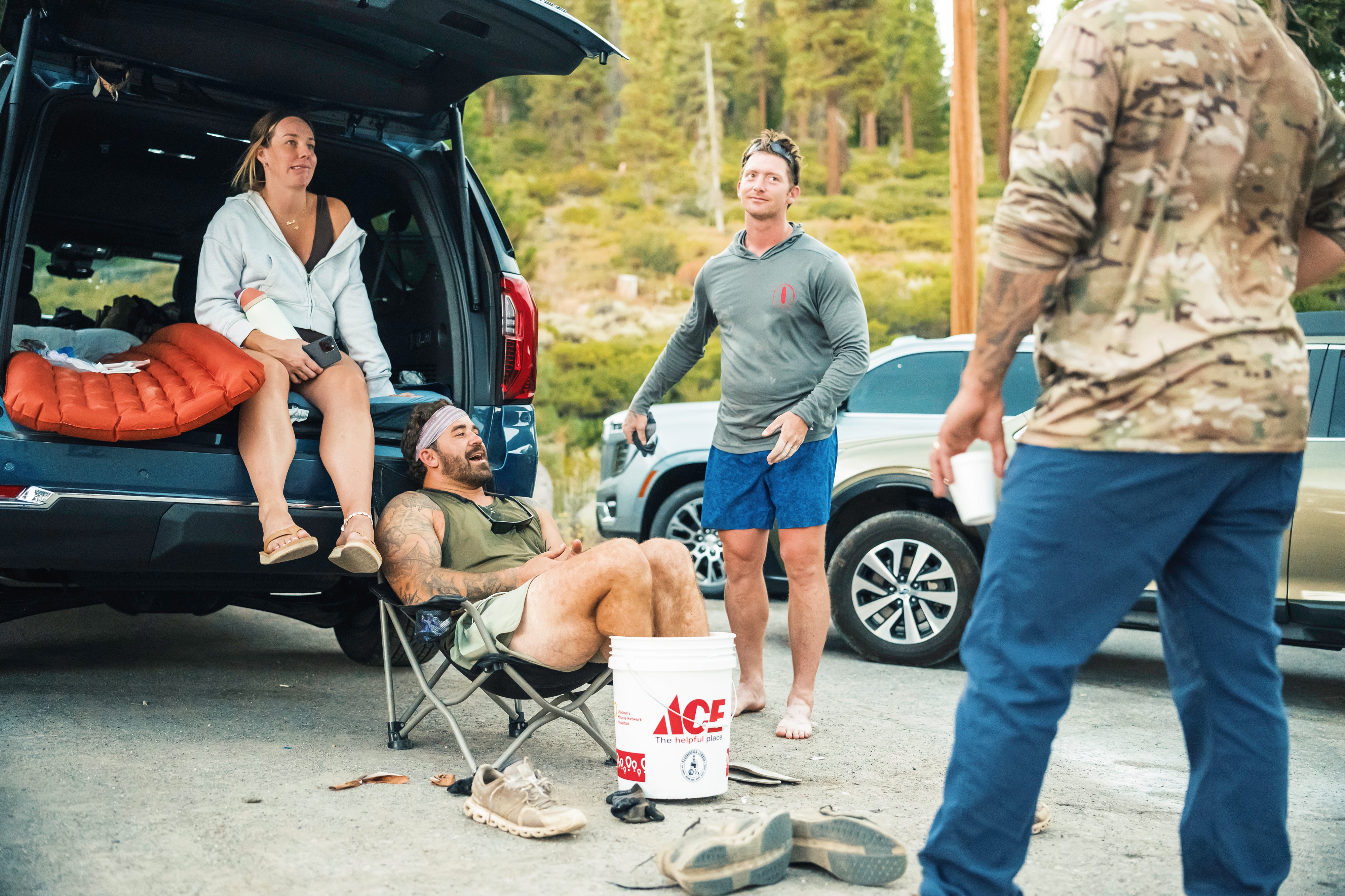 Navy Seal Kyle Reed icing his feet in a bucket outside of a vehicle during the 20 Mountain 220 journey.