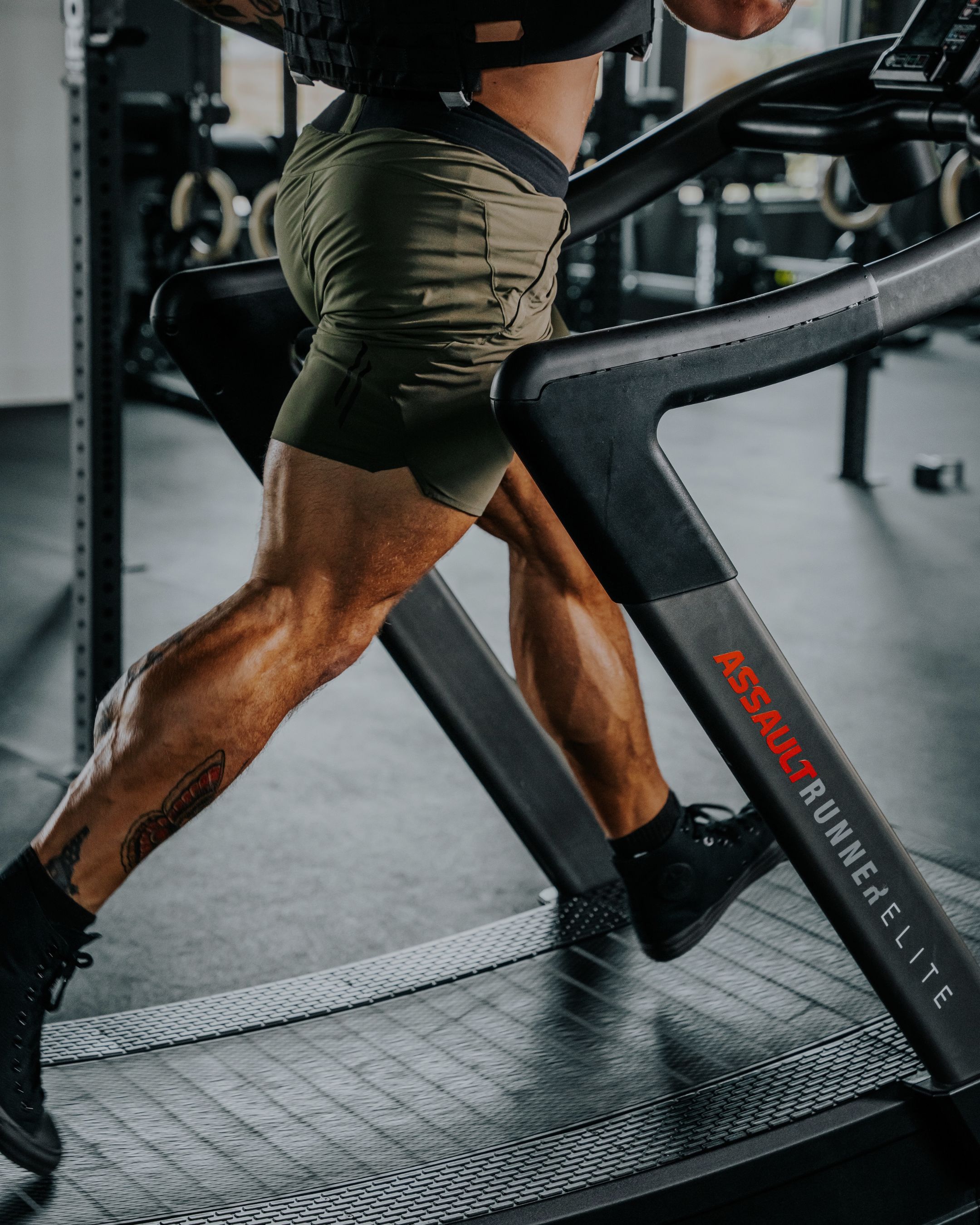 Person running on a treadmill in a gym setting
