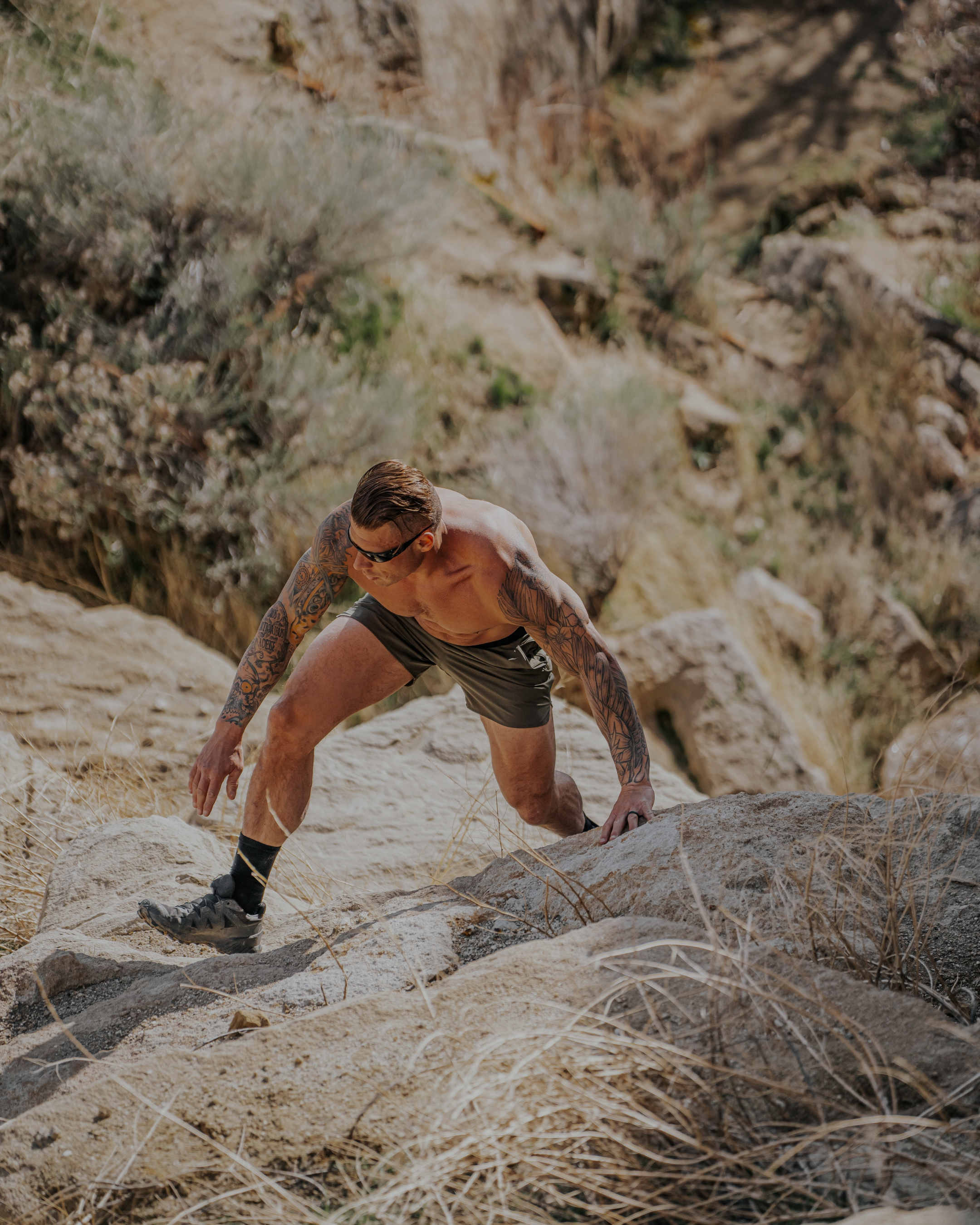 Man climbing a rocky mountain trail in a natural setting