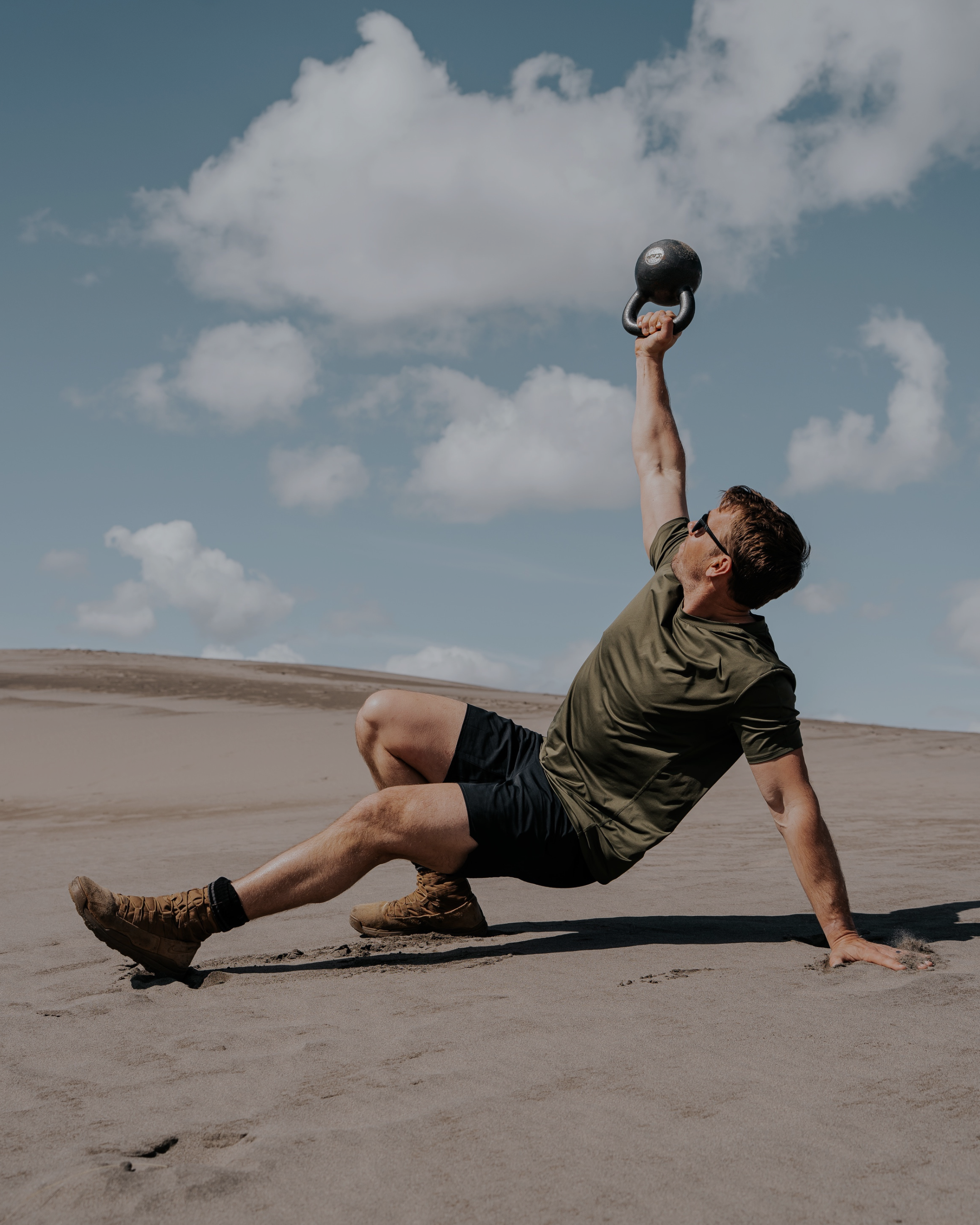 Person exercising with a kettlebell in a desert setting