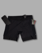 Black athletic shorts with a phone and tags on a gray background
