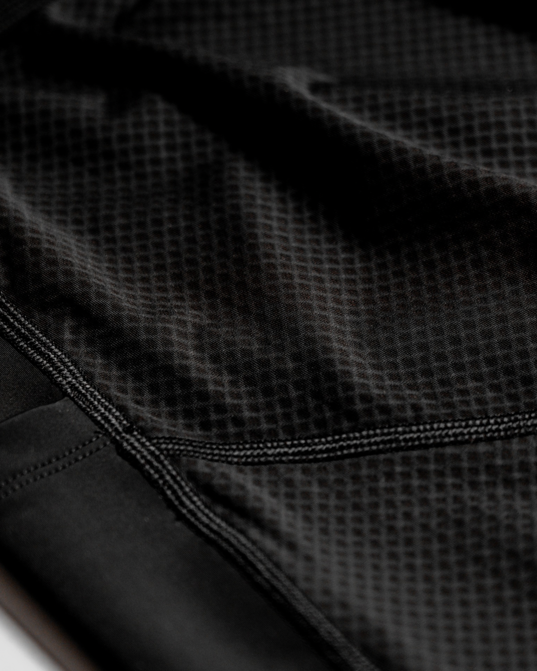Close-up of black textured fabric with a zipper