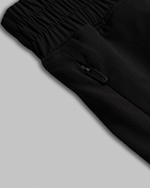 Black womens athletic shorts with a zipper detail on a light gray background